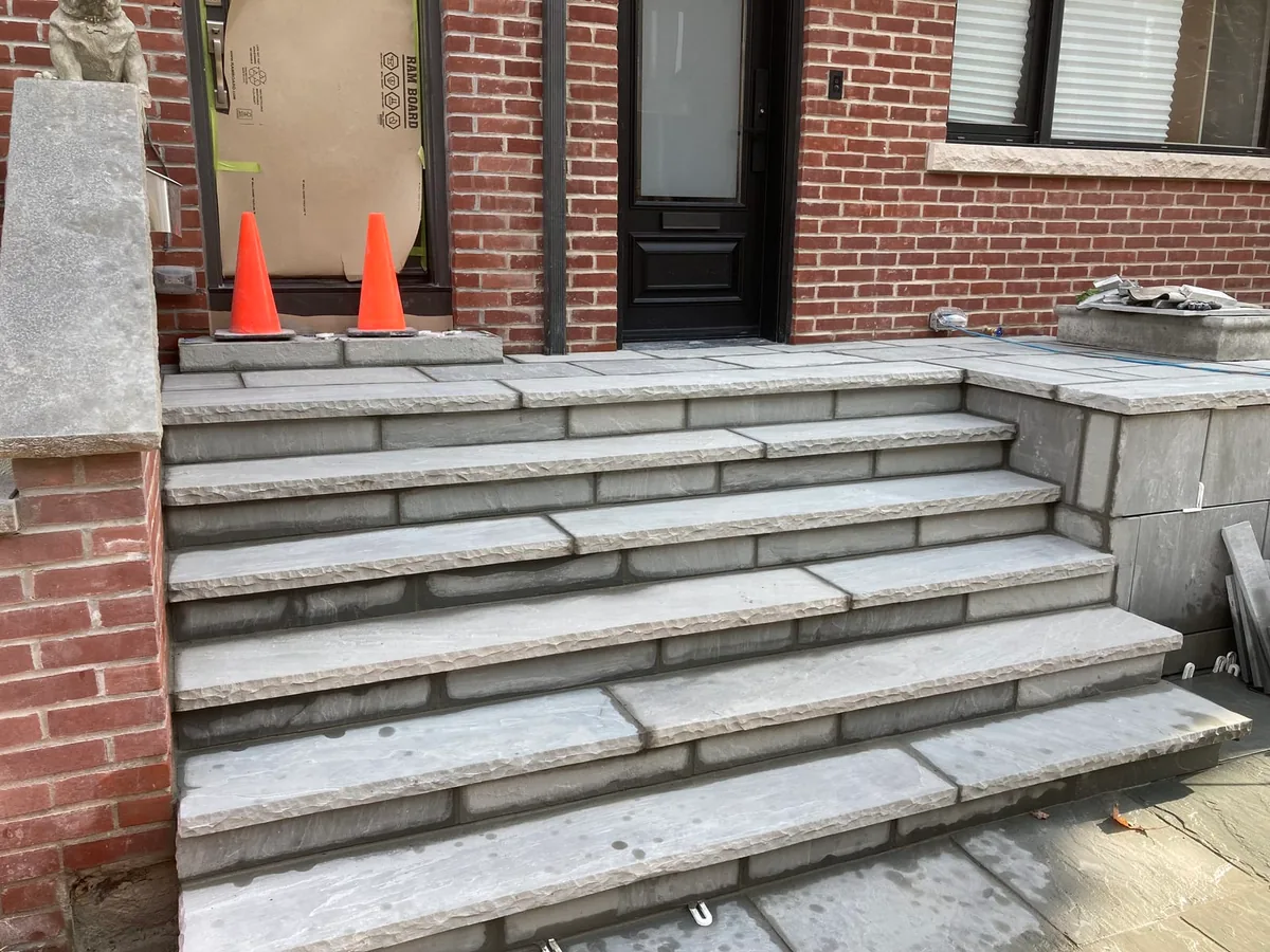 The finished steps from a different angle, with cones and a small lion statue visible.