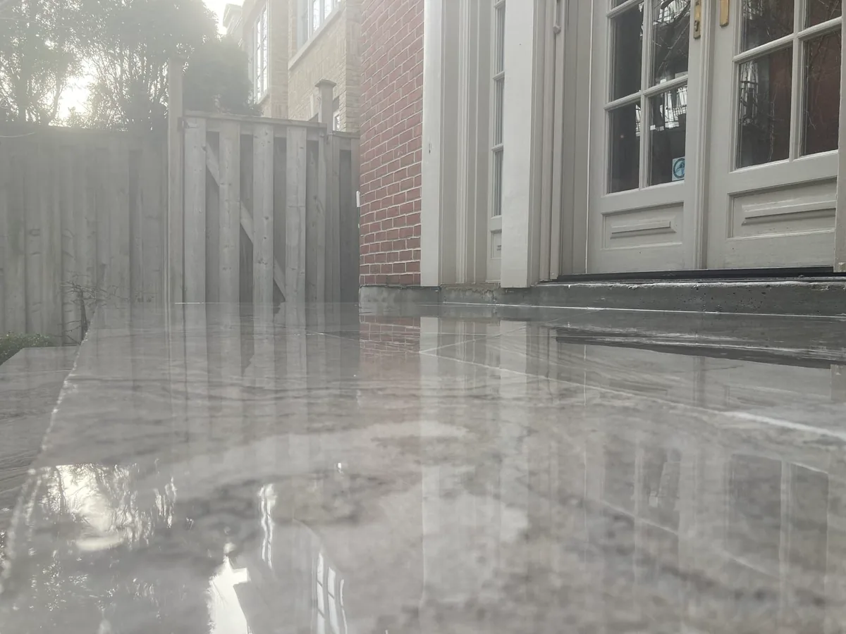 A similar reflective marble patio shot near the French doors.