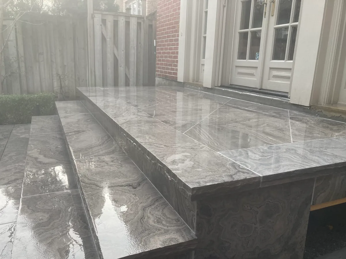 A close detail of the marble tile pattern on the patio.